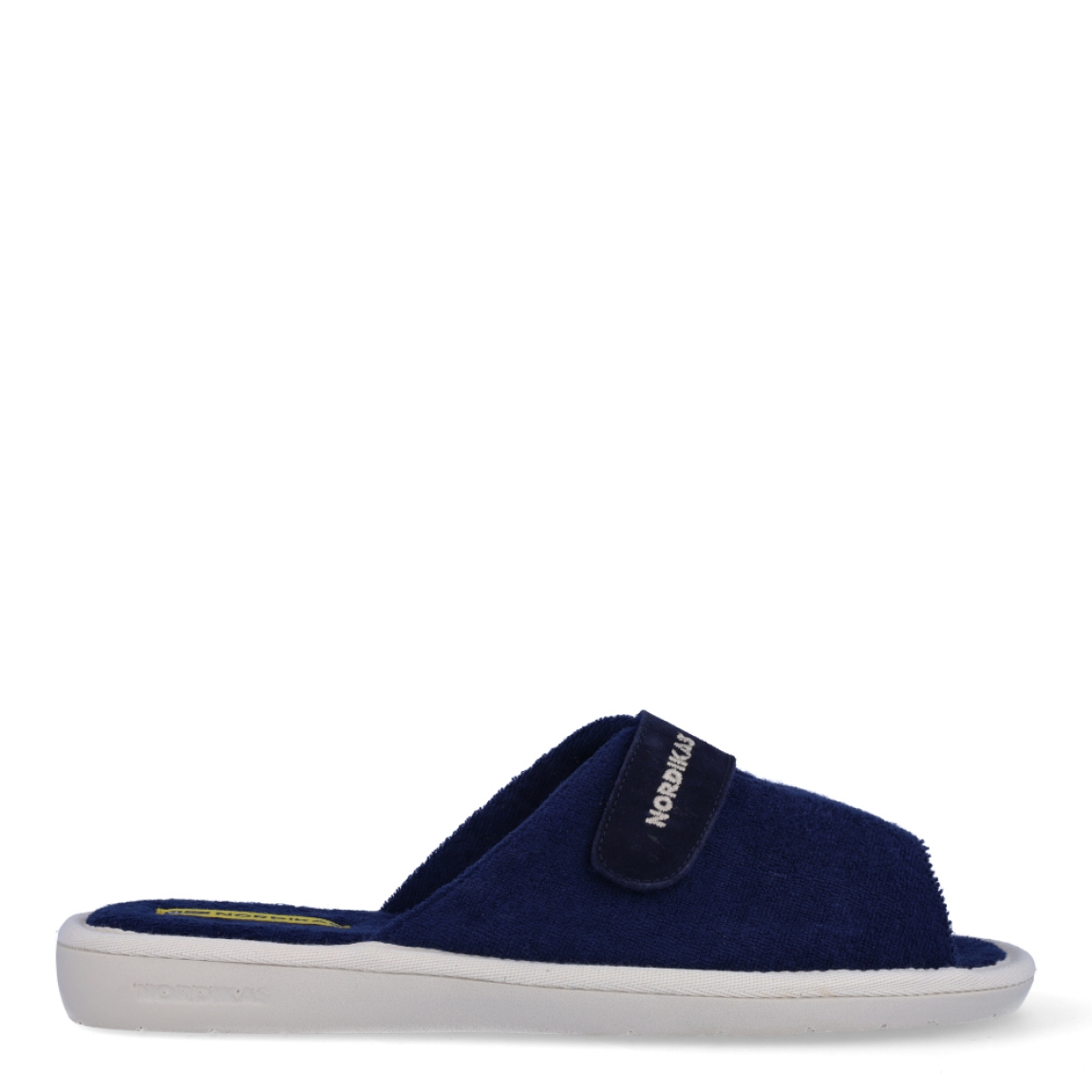 Zapatillas de la marca Nordikas, modelo TOP LINE. Exterior e interior de las zapatillas en toalla color azul. Cierre de las zapatillas con velcro y suela de goma plana. Estas zapatillas Nordikas TOP LINE, te hará disfrutar de la comodidad y ligereza de estar por casa.