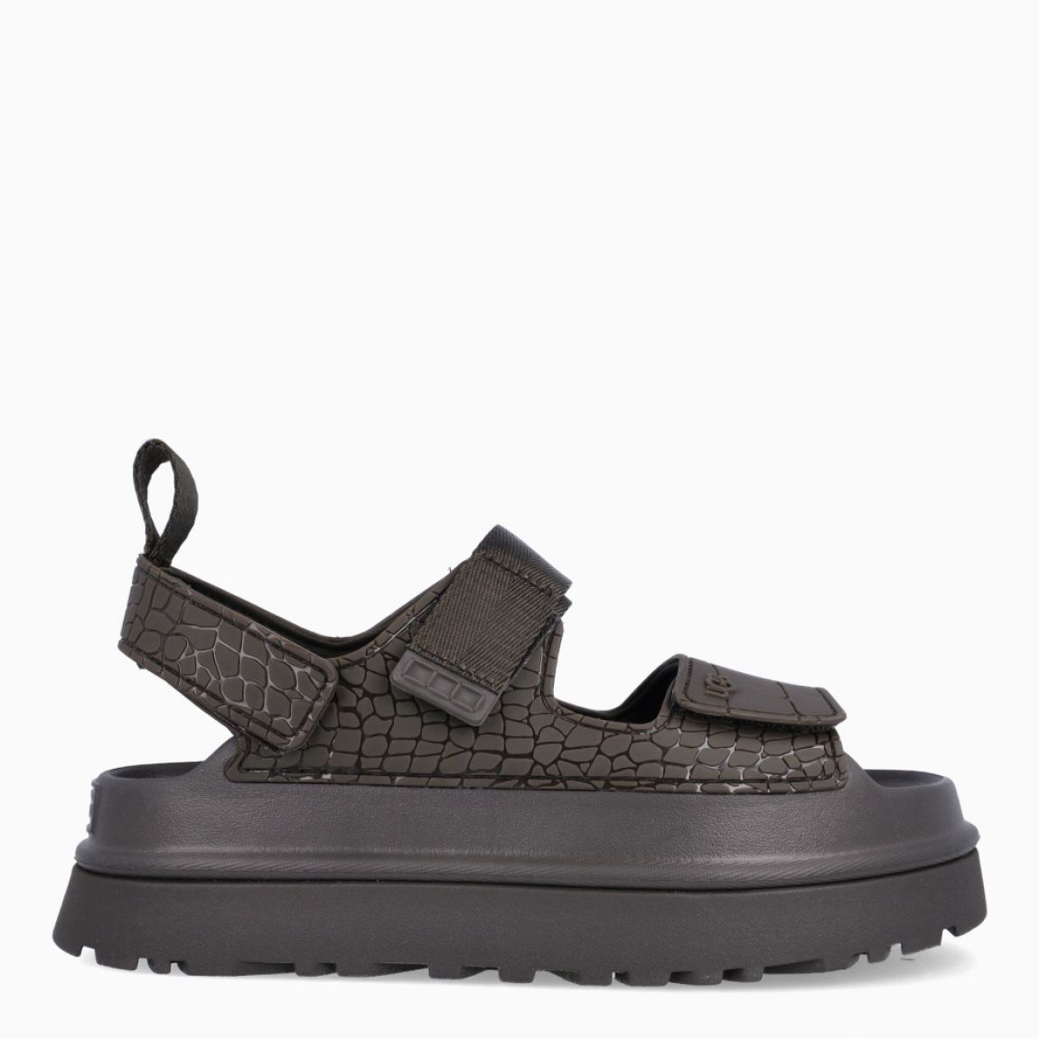 Sandalias de la marca UGG, modelo GOLDENGLOW. Sandalias con forro del empeine fabricado con fibras de poliéster 100 % reciclado color verde con estampado de cocodrilo. Empeine de TPU grabado. Cierre de las UGG con velcro en pala y tobillo, las tiras están fabricadas con fibras de poliéster 100 % reciclado. Entresuela de EVA de caña de azucar. Suela de goma con plataforma. Estas sandalias UGG GOLDENGLOW son un complemento que te brindará una comodidad única!