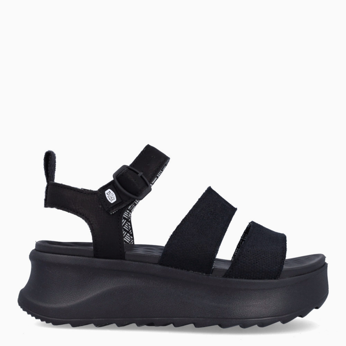 Sandalias de la marca Heydude, modelo DELRAY BUCKLE. Exterior elaborado en tela color negro. Interior en piel color negro. Cierre de sandaias Heydude con hebilla en tobillo. Sandalias con cuña de 5cm de altura. Estas sandalias Heydude DELRAY BUCKLE son un complento básico, clásico y cómodo para tu día a día!