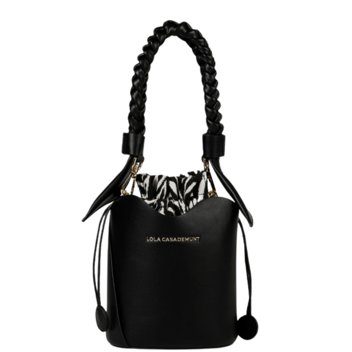 Bolso de la marca Lola Casademunt, modelo BOMB. Exterior en piel color negro con asa corta trenzada. Incluye saco interior con estampado cebra, asa larga y cierre ajustable con cordón. Medidas alto 18cm y ancho 18cm. Este bolso Lola Casademunt BOMB es ideal para llevarlo a todos lados!