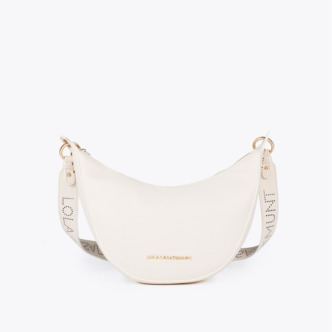 Bolso bandolera mini hobo de la marca Lola Casademunt, modelo ANAHI. Exterior en efecto piel color blanco y detalles de tachuelas planas. Contiene compartimento interior y asa bandolera troquelada. Cierre con cremallera.ALTO: 21 cm - LARGO: 38 cm - ANCHO: 10 cm / BANDOLERA: 87 cm
