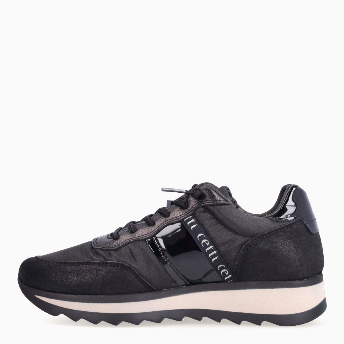 Deportivas de la marca Cetti, modelo C-849. Exterior de las deportivas en naylon color negro con efecto brillante. Interior de las deportivas en piel color negro. Cierre de las deportivas Cetti con cordones elásticos. Deportivas con cuña de 3cm de altura. Estas deportivas Cetti C-849 son unas clásicas, con estilo y comodidad que no pueden faltar en tu armario.