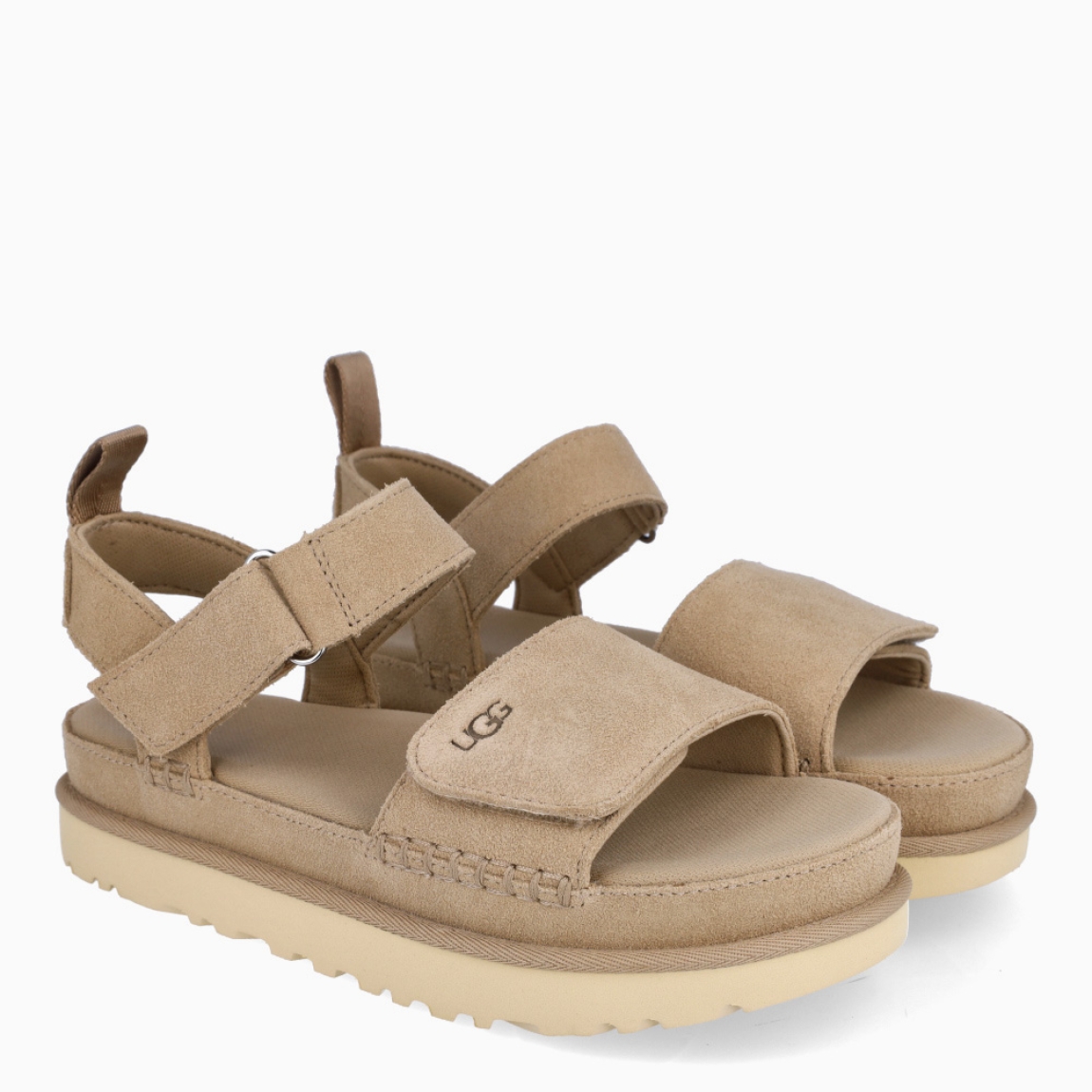 Sandalias de la marca UGG, modelo GOLDENSTAR. Sandalias elaboradas en ante color camel. Forro textil de fibras de poliéster 100 % reciclado, forro de microfibra. El tejido de la plantilla está fabricado con fibras de poliéster 100 % reciclado, la plantilla cuenta con un tratamiento antiolores a base de menta. Cierre de estas sandalias UF co veñcrp en el tobillo y empeine. Entresuela de EVA de caña de azúcar reciclada. Suela de goma EVA de caña de azúcar. Sandalias UGG GOLDENSTAR es un complemento básico e ideal en comodidad!