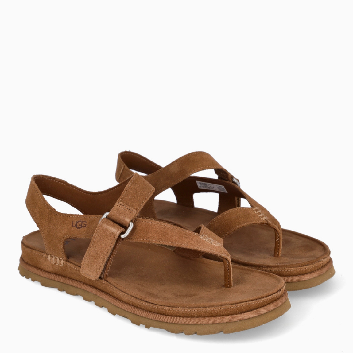 Sandalias esclava de la marca UGG, modelo GOLDENSTAR. Sandalias elaboradas en ante color cuero. Forro textil de fibras de poliéster 100 % reciclado, forro de microfibra. El tejido de la plantilla está fabricado con fibras de poliéster 100 % reciclado, la plantilla cuenta con un tratamiento antiolores a base de menta. Cierre de estas sandalias con tiras cruzadas y velcro en pala. . Entresuela de EVA de caña de azúcar reciclada. Suela de goma EVA de caña de azúcar. Sandalias esclava UGG GOLDENSTAR es un complemento básico e ideal en comodidad!