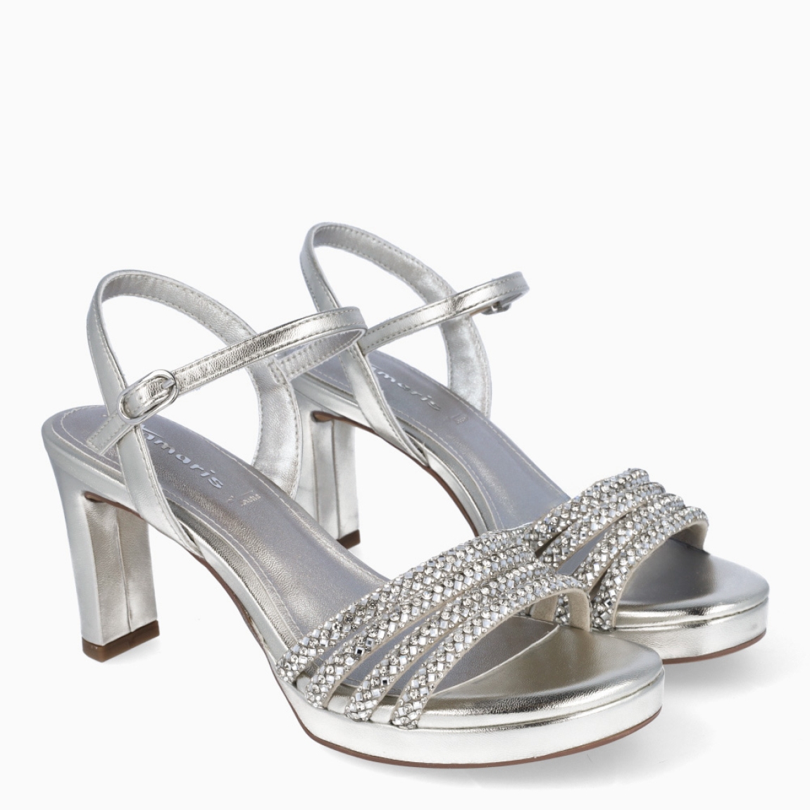 Sandalias de la marca Tamaris, modelo MAGDA. Sandalias elaboradas en ecopiel color plata con tiras en la pala con piedrería brillante. Interior en piel color plata. Cierre de sandalias Tamaris con hebilla en tobillo y tacón de 9cm de altura. Sandalias Tamaris MAGDA complemento ideal para lucir tus looks en eventos!