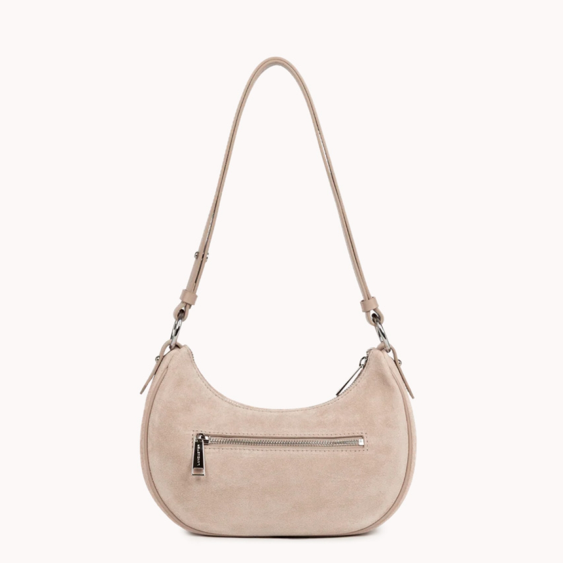 Este pequeño bolso bandolera de la marca Lancaster, modelo Suède está confeccionado en cuero de vaca con efecto ante de color beig. Incluye un bolsillo interior simple, un bolsillo interior con cremallera y un bolsillo trasero exterior con cremallera. Se puede llevar al hombro o cruzado. Bolso con logotipo en parte frontal. Bolso Lancaster Suède se ha convertido en un complemento ideal para llevar a todos lados, su forma en media luna le da un estilo único!