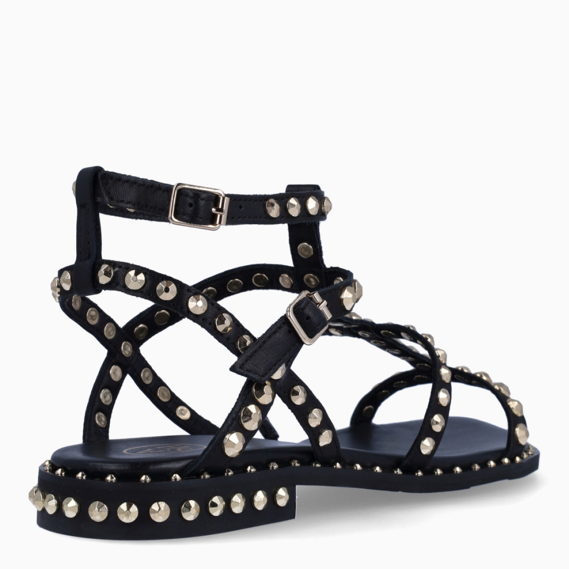 Sandalias de la marca ASH, modelo PRECIOUS. Elaboradas en piel color negro con detalle de tachuelas doradas y tiras hasta arriba. Interior en piel color negro. Cierre de sandalias ASH con doble hebilla en tobillo. Suela plana de goma. Estas sandalias ASH PRECIOUS son ideales para llevar tus looks de temporada con estilo y comodidad!