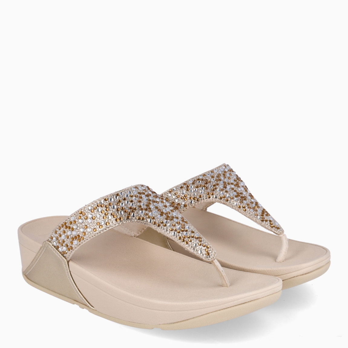 Sandalias de la marca Fitflop, modelo LULU. Sandalias elaboradas en neopreno color platino con brillantes en pala. Interior de esclavas en neopreno color nude. Suela de goma con una cuña de 6cm de altura. Estas sandalias Fitflop LULU son ideales para esta temporada!