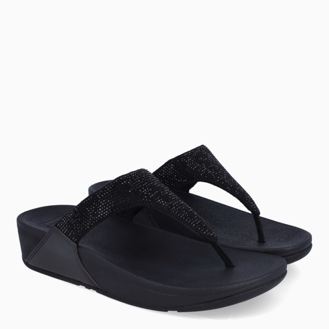 Sandalias de la marca Fitflop, modelo LULU. Sandalias elaboradas en neopreno color negro con brillantes en pala. Interior de esclavas en neopreno color negro. Suela de goma con una cuña de 6cm de altura. Estas sandalias Fitflop LULU son ideales para esta temporada!