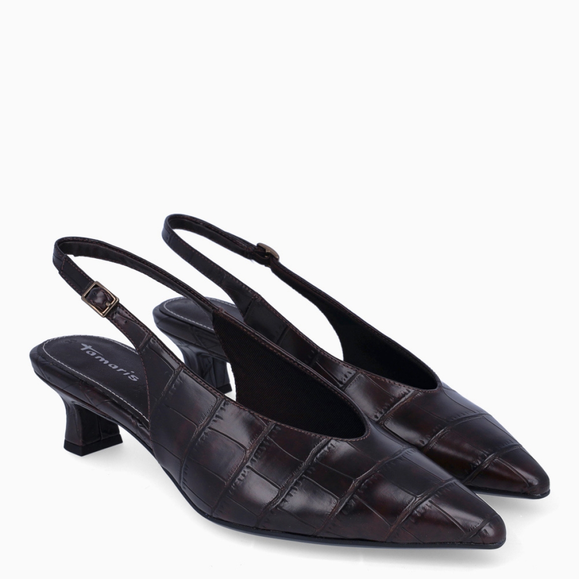 Los salones Tamaris QUEENIE combinan elegancia y comodidad en un diseño perfecto para cualquier ocasión. Están confeccionados en piel de color marrón con un sofisticado acabado efecto cocodrilo, que aporta un toque distintivo y actual. Incorporan un tacón de 4 cm de altura, ideal para proporcionar una ligera elevación y garantizar el confort durante largas jornadas. Su punta afilada realza la silueta del calzado con un aire refinado y femenino. Cuentan con cierre mediante hebilla ajustable para un ajuste seguro y personalizado, además de una plantilla suave que ofrece una mayor comodidad en cada paso. Los Tamaris QUEENIE son la opción perfecta para transformar cualquier look en un conjunto formal y elegante, sin renunciar a un estilo moderno y versátil.