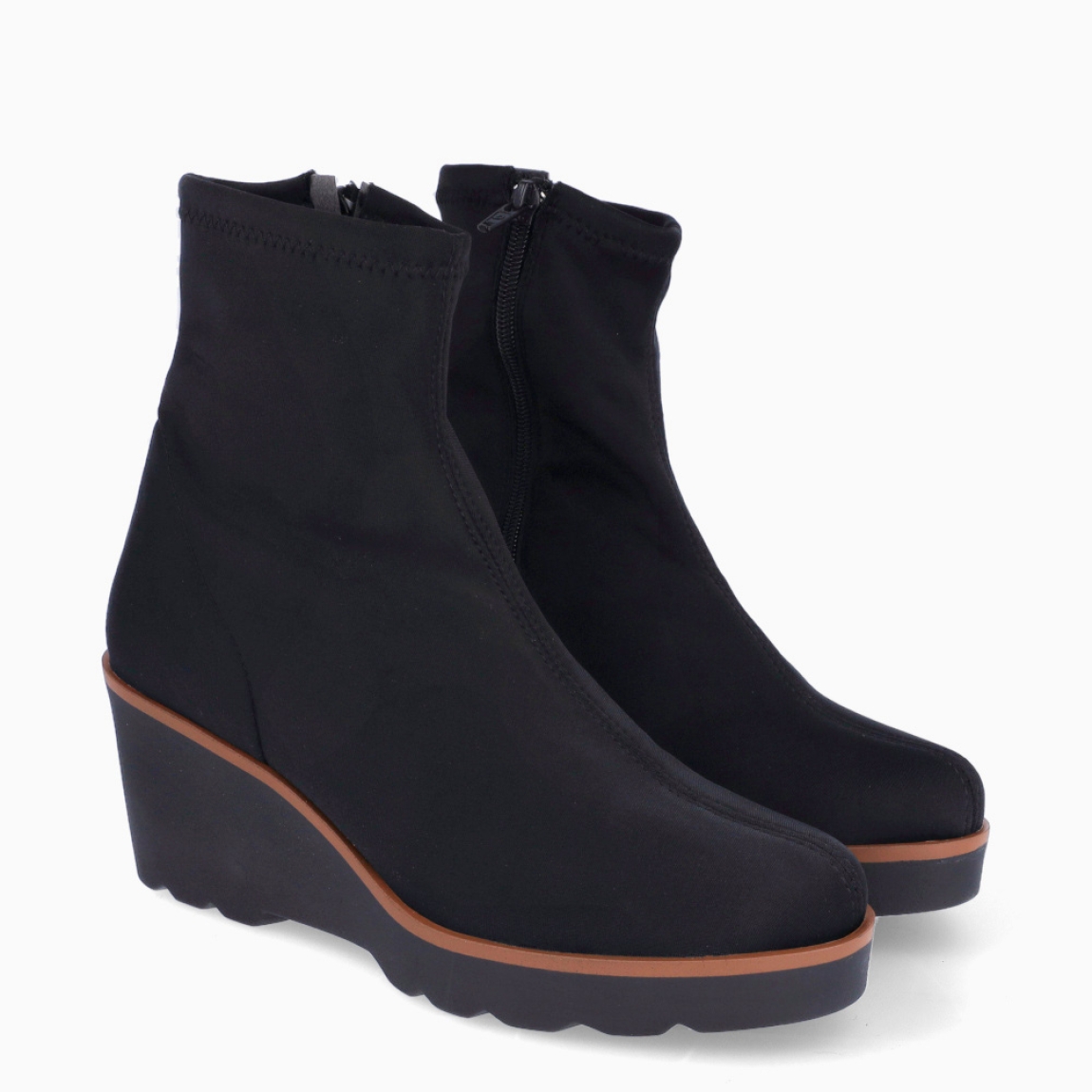 Botines de la marca Munné, modelo ADELFA. Botines elaborados en licra color negro. Botines adaptables para el día a día, que brinda la mayor comodidad en cada paso. Botines Munné con cierre de cremallera y tacón con una cuña de 4cm de altura. Estos botines Munné ADELFA son ideales para ti!