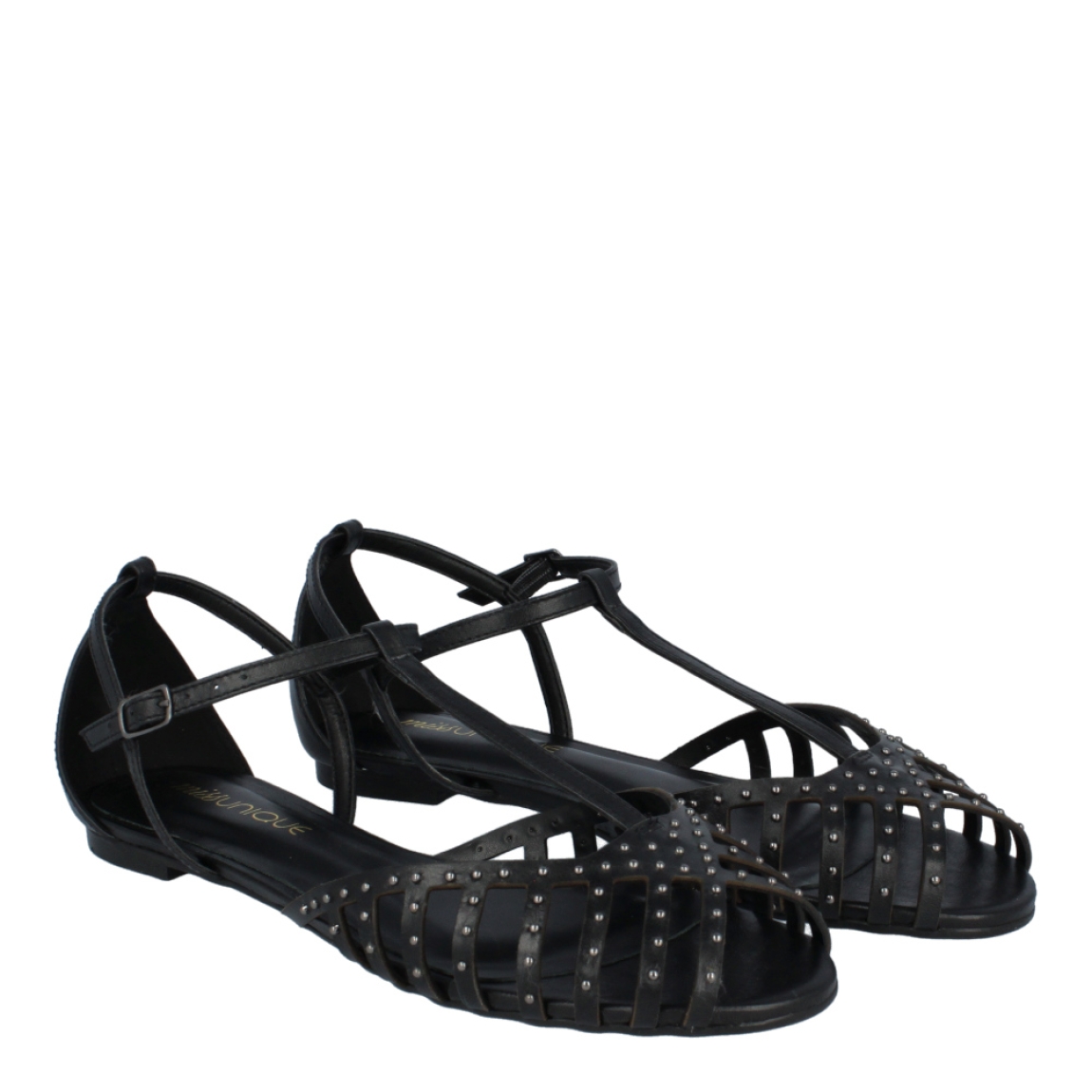 Sandalias de la marca Unique, modelo ELECTRA. Exterior de las sandalias en piel color negro con detalle en tachas. Interior de las sandalias en piel color negro. Cierre de las sandalias UNIQUE con hebilla en el tobillo. Estas sandalias Unique ELECTRA traen un diseño que te ayudará a lucir unos looks con estilo y comodidad a donde vayas.