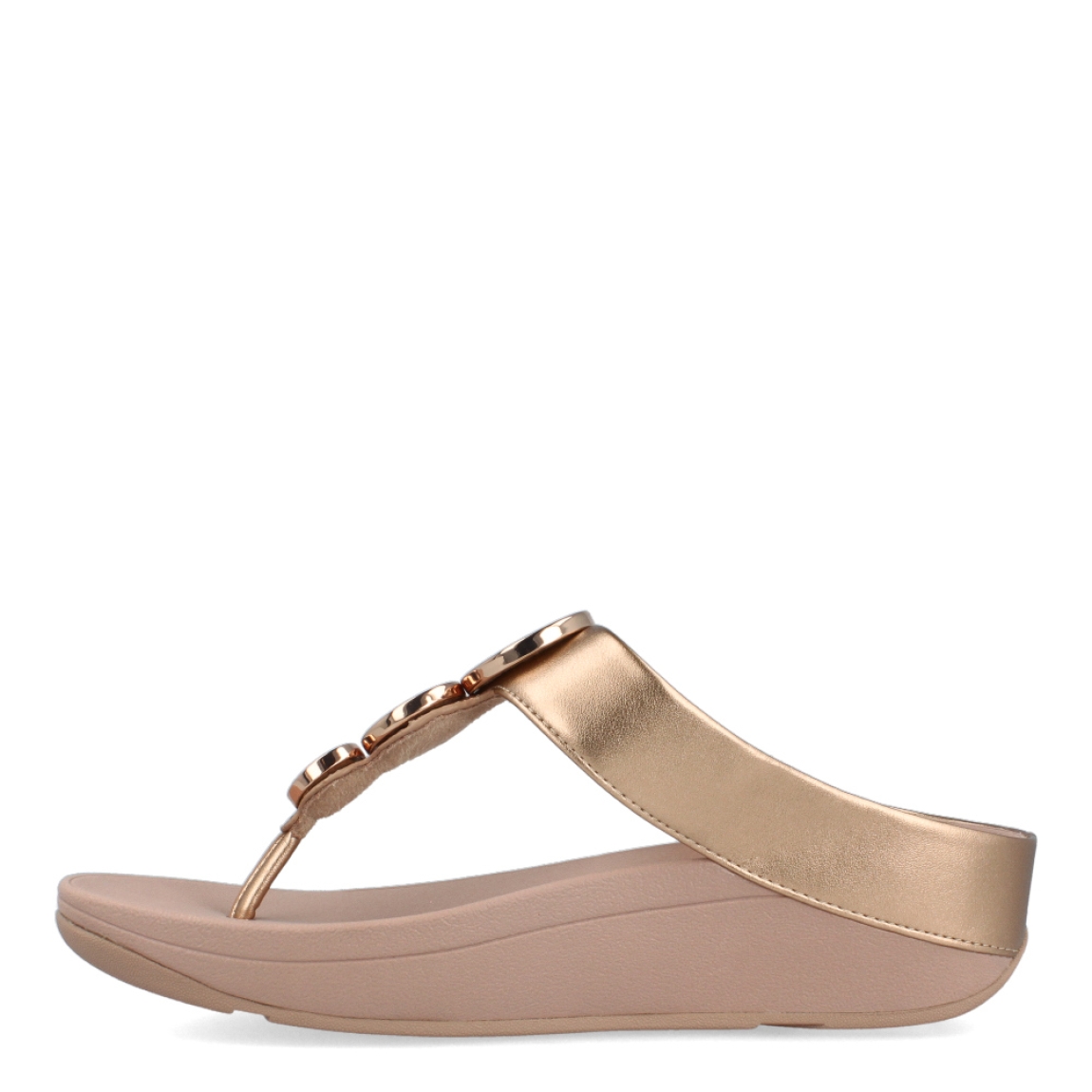 Esclavas de la marca Fitflop, modelo HALO. Esclavas elaboradas en piel color nude con detalle de círculos dorados brillantes en la pala. Esclava Fitflop con cuña de 4cm de altura. Estas esclavas Fitflop HALO son un complemento básico para esta temporada, disfrutarás de una comodidad excepcional en tu día a día.