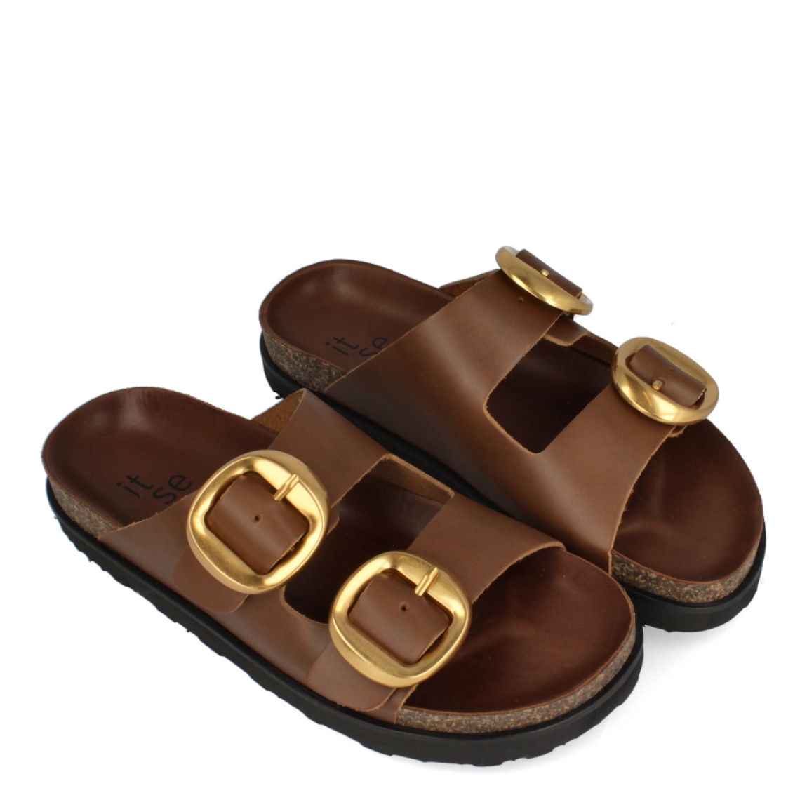 Sandalias de la marca Itse, modelo GEMMA. Sandalias elaboradas en piel color cuero con doble hebilla en la parte de la pala color dorado. Sandalias Itse con suela plana de corcho. Estas sandalias Itse GEMMA son un complemento básico para tus looks de temporada. No puede faltar en el armario.