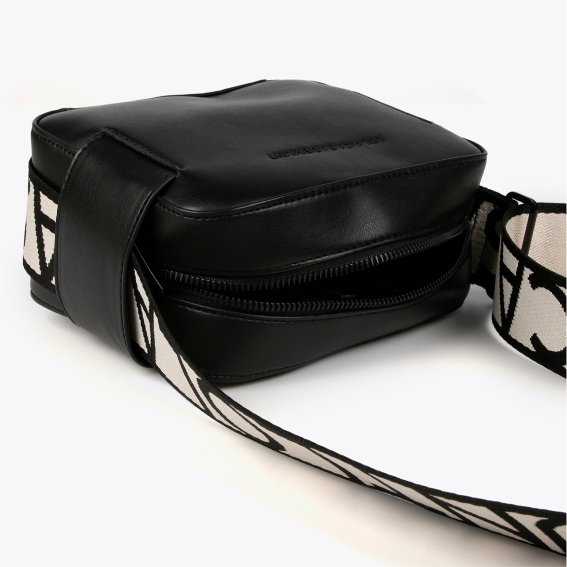 Bolso de la marca Lola Casademunt, modelo NOA. Bolso bandolera elaborado en piel color negro con logo de la marca en la parte frontal. Cuenta con compartimento interior amplio y un bolsillo interior. Cierre con cremallera y asa extraíble con estampado de la marca en negro y blanco. Medidas del bolso: alto 14cm y ancho 18cm. Este bolso Lola Casademunt NOA es un clásico, con un estilo versátil y atemporal. Perfecto para combinarlo con todos tus looks!