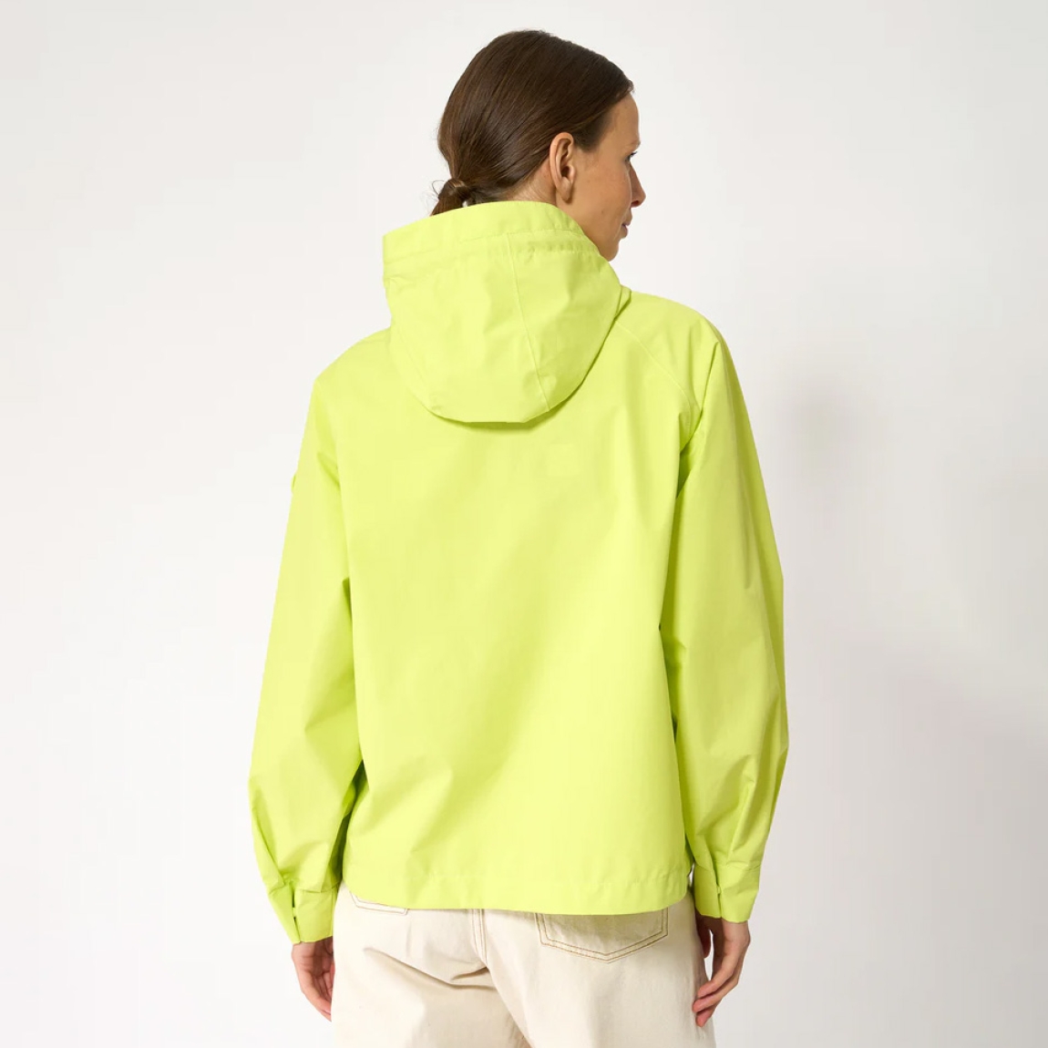 Chaqueta impermeable corta de la marca Tanta, modelo Dhuda. Tiene corte holgado y está confeccionada con un tejido de mezcla de algodón impermeable color fluor. Este material atemporal es transpirable y resistente al viento. Los detalles de la prenda incluyen costuras selladas, mangas raglán, una cremallera de doble cursor y cierres a presión ocultos. Su elegante silueta en línea A cuenta con aberturas laterales redondeadas para un look más femenino.