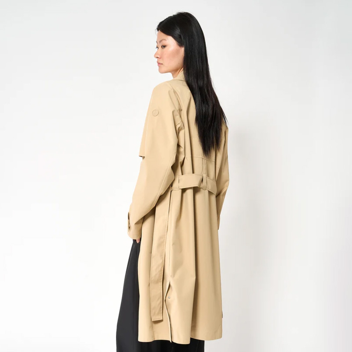 Chaqueta impermeable sin costuras de la marca Tanta, modeloTage. Chaqueta confeccionada en tejido de sarga de poliéster color camel. Es 100% impermeable y cuenta con todas las costuras selladas para una protección superior. Los detalles de la prenda incluyen dos canesús en la parte delantera y uno en la parte trasera, botones a presión ocultos, una cintura ajustable con cinturón y una capucha desmontable con cordón ajustable. Diseñado con un corte impecable, el modelo Tage combina elegancia con una alta funcionalidad.