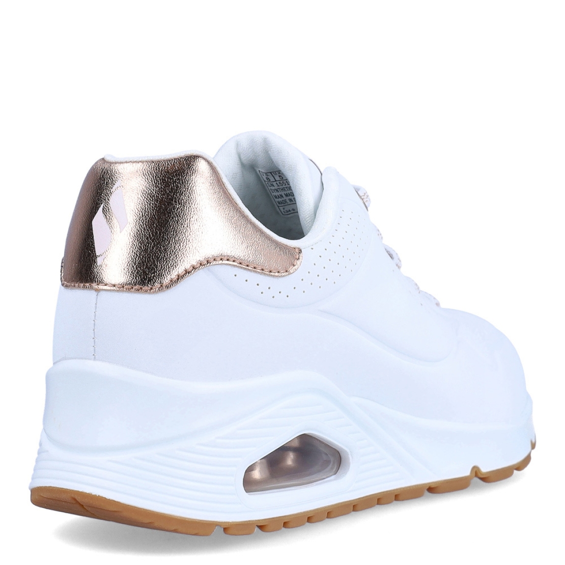 Deportivas de la marca Skechers, modelo UNO FLEX. Exterior en piel con detalle troquelado color blanco con detalle del logo en parte lateral y color bronce en talón. Interior en textil color blanco con plantilla acolchada y extraíble para máxima comodidad. Cordones de color blanco y una cuña de 3cm de altura. Estas deportivas Skechers UNO FLEX son unas clásicas, ideales para tu día a día.
