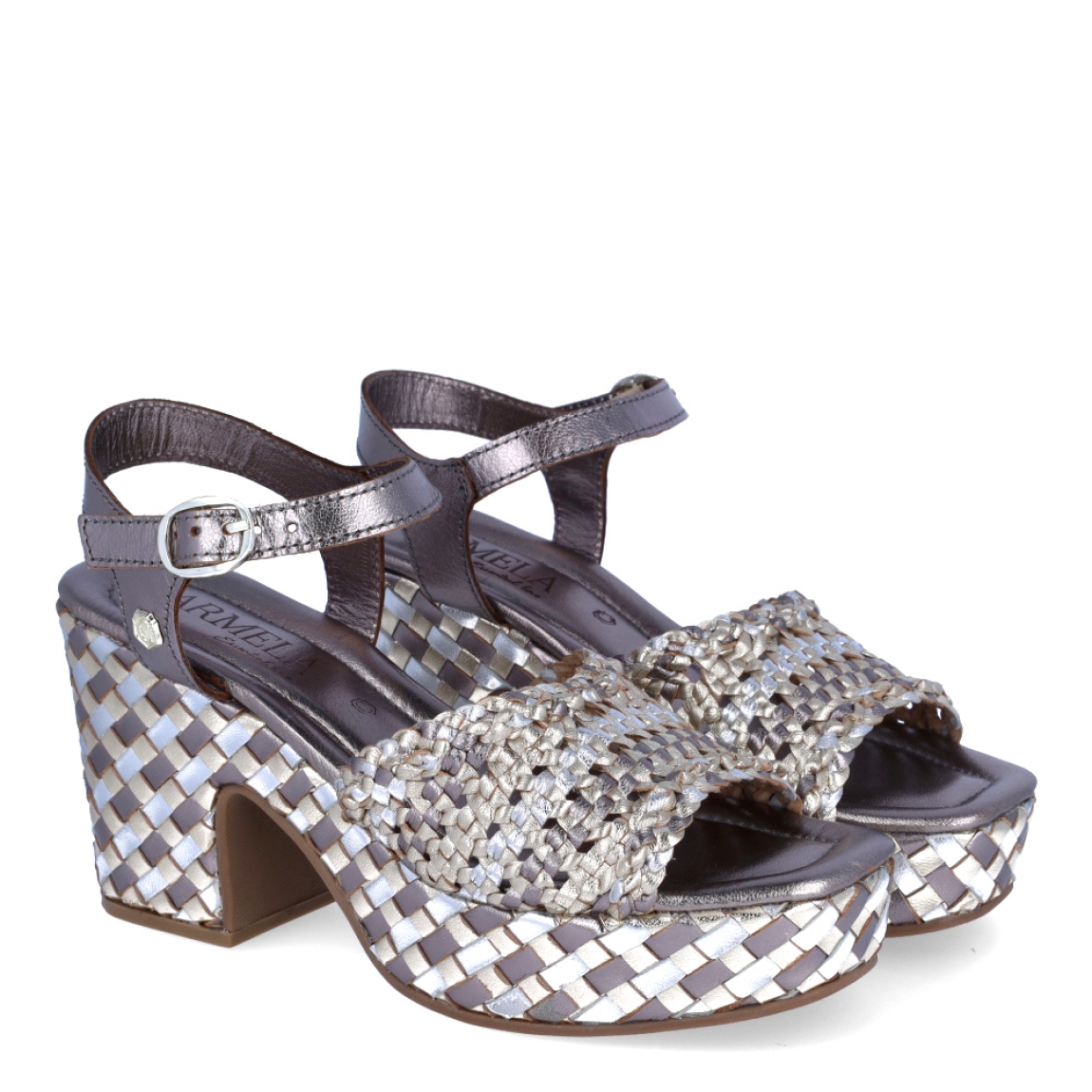Sandalias de la marca Carmela, modelo SUSAN. Exterior en piel trenzada color platino en tonalidades. Interior en piel color platino. Cierre con hebilla en el tobillo y tacón de 9cm de altura. Estas sandalias Carmela SUSAN son ideales para esta temporada!