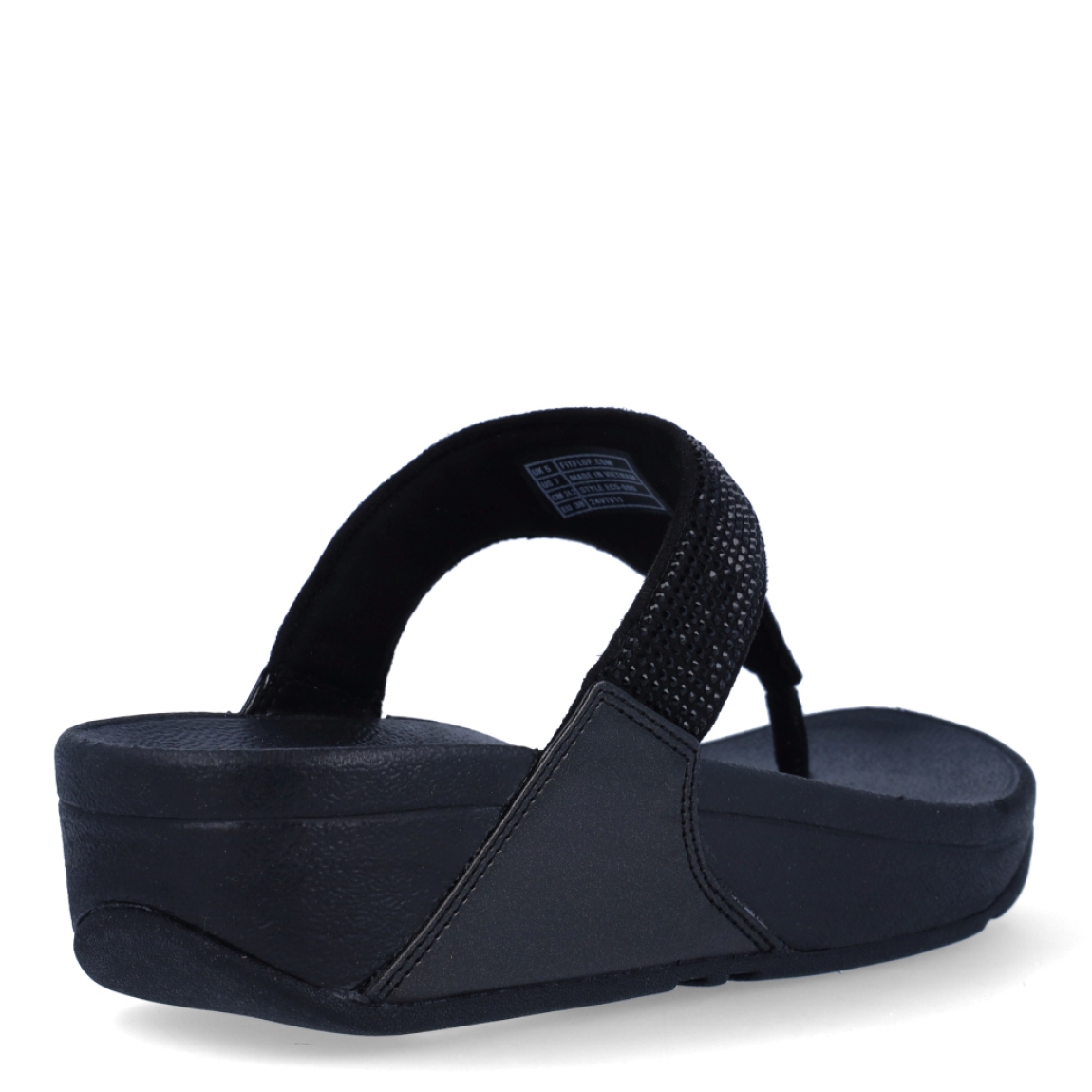 Sandalias de la marca Fitflop, modelo Lulu Crystal. Exterior en ante color negro, decorado con brillantes. Interior en microfibra de color taupe. Suela de caucho antideslizante y planta acolchada. Cuña de 4 cm incluyendo 2,5 cm de plataforma. Con detalle de piel sintética perlada metalizada en los laterales. Fabulosas de día y de noche.