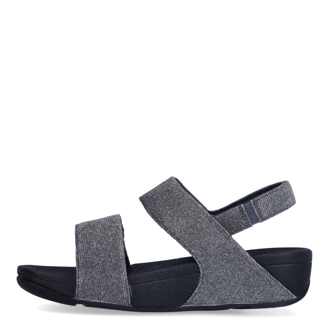 Sandalias de la marca Fitflop, modelo LULU ADJUSTABLE. Exterior en neopreno color gris, decorado con brillantes en pala. Interior en microfibra de color negro. Cierre con doble velcro en la pala. Suela de caucho antideslizante y planta acolchada. Cuña de 4 cm incluyendo 2,5 cm de plataforma. Con detalle de piel sintética perlada metalizada en los laterales. Fabulosas de día y de noche.