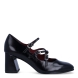 Zapatos estilo merceditas de tacón de la marca Tamaris, modelo CHARLOTTE. Confeccionadas en suave piel negra de primera calidad, destacan por su diseño retro de triple tira sobre el empeine y puntera ligeramente cuadrada. Incorporan tres hebillas metálicas ajustables para una sujeción a medida, plantilla interior acolchada de alto confort y un tacón ancho y geométrico de 6 cm con piso de goma flexible, que garantiza una pisada firme y estable. Ideales para combinar con minifaldas de tablas, vestidos evasé o tejanos anchos con blazer para un estilismo parisino impecable. ¡Elegancia y tendencia sin renunciar a la comodidad!