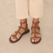 Sandalias de la marca ASH, modelo PRECIOUS. Elaboradas en ante color marrón con detalle de tachuelas doradas y tiras hasta arriba. Interior en ante color marrón. Cierre de sandalias ASH con doble hebilla en tobillo. Suela plana de goma. Estas sandalias ASH PRECIOUS son ideales para llevar tus looks de temporada con estilo y comodidad!