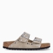 Sandalias de la marca Birkenstock, modelo ARIZONA RIVET. Sandalias elaboradas en ante de color taupe con detalle de tachuelas y con una base de corcho y látex de forma anatómica. Cierre de las sandalias con doble hebilla de espiga de metal con ajuste individual. Estas sandalias Birkenstock ARIZONA RIVET es un complemento clásico para tus looks de temporada, con un diseño sencillo atemporal y una ligereza que te dará la comodidad que necesitas en tu día a día.