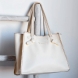 Bolso shopper Noco, modelo SHANON. Elaborado de piel vegana color blanco. Este bolso es una pieza única que combina estilo y sostenibilidad. Su formato se distingue por su trabajo de diseño original, aportando una forma sofisticada y funcional. El material de piel vegana tiene un acabado que imita a la perfección la piel real, con un suave interior similar al pelo característico de la piel auténtica, brindando una textura premium. Cierre con boton. Medidas alto 26cm y ancho 30cm.